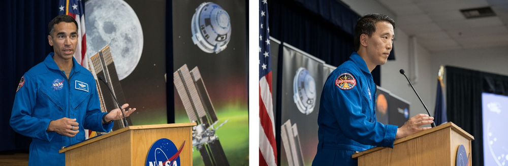 Two astronauts wearing blue flight suits stand behind podiums, delivering remarks to a crowd that is not pictured.